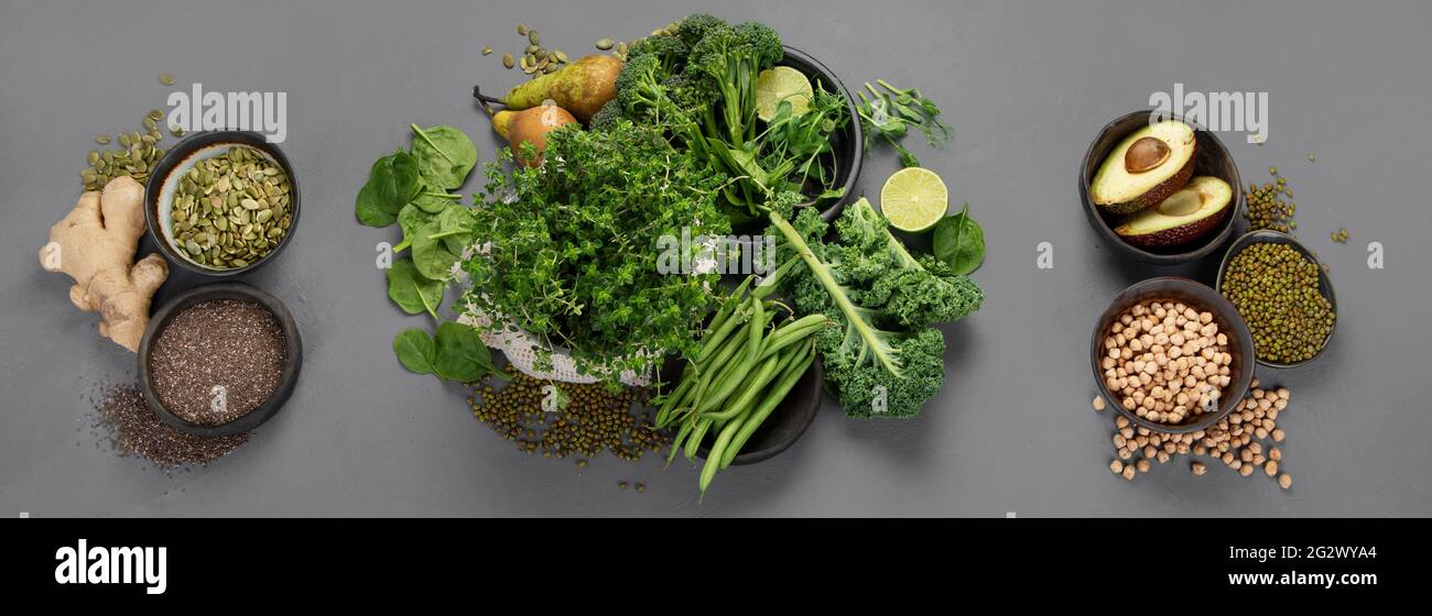 Assorted green vegetables and cereal on gray background. Healthy food ...