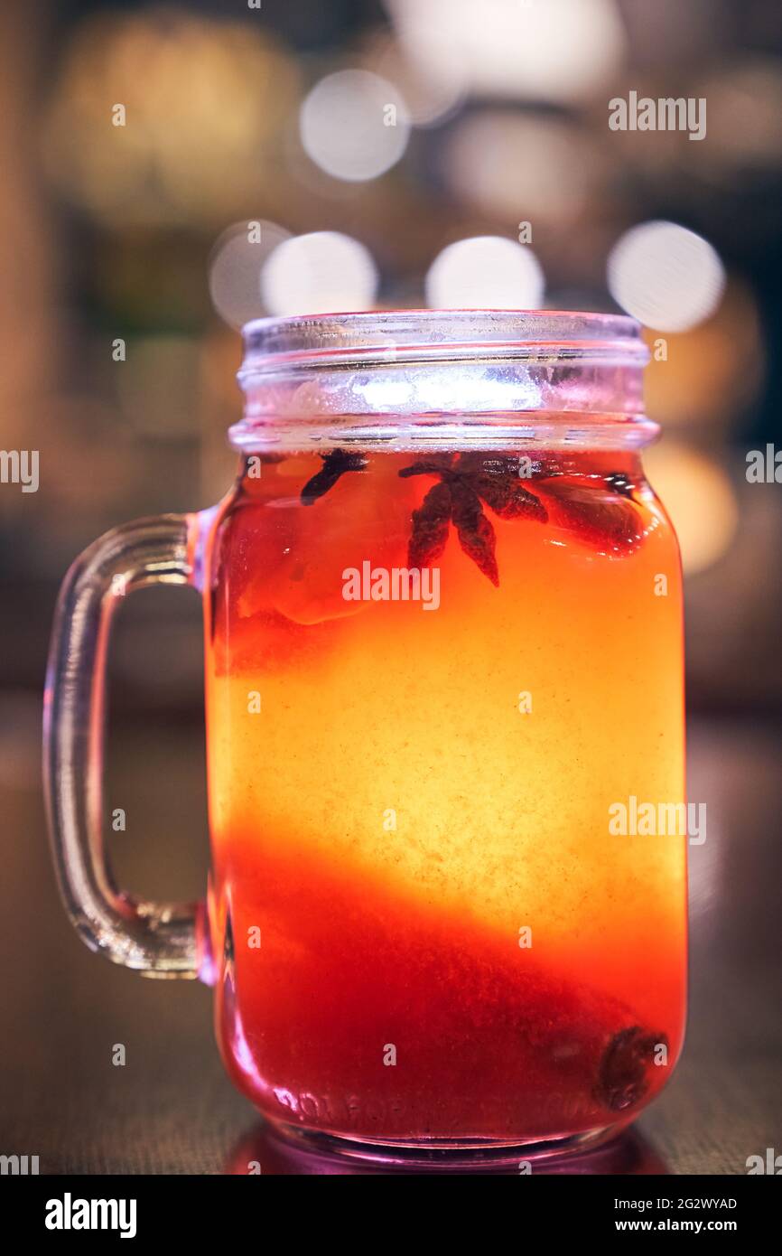 Close up of red drink non-alcoholic mulled wine with a straw on the background of the cafe interior, order for one Stock Photo