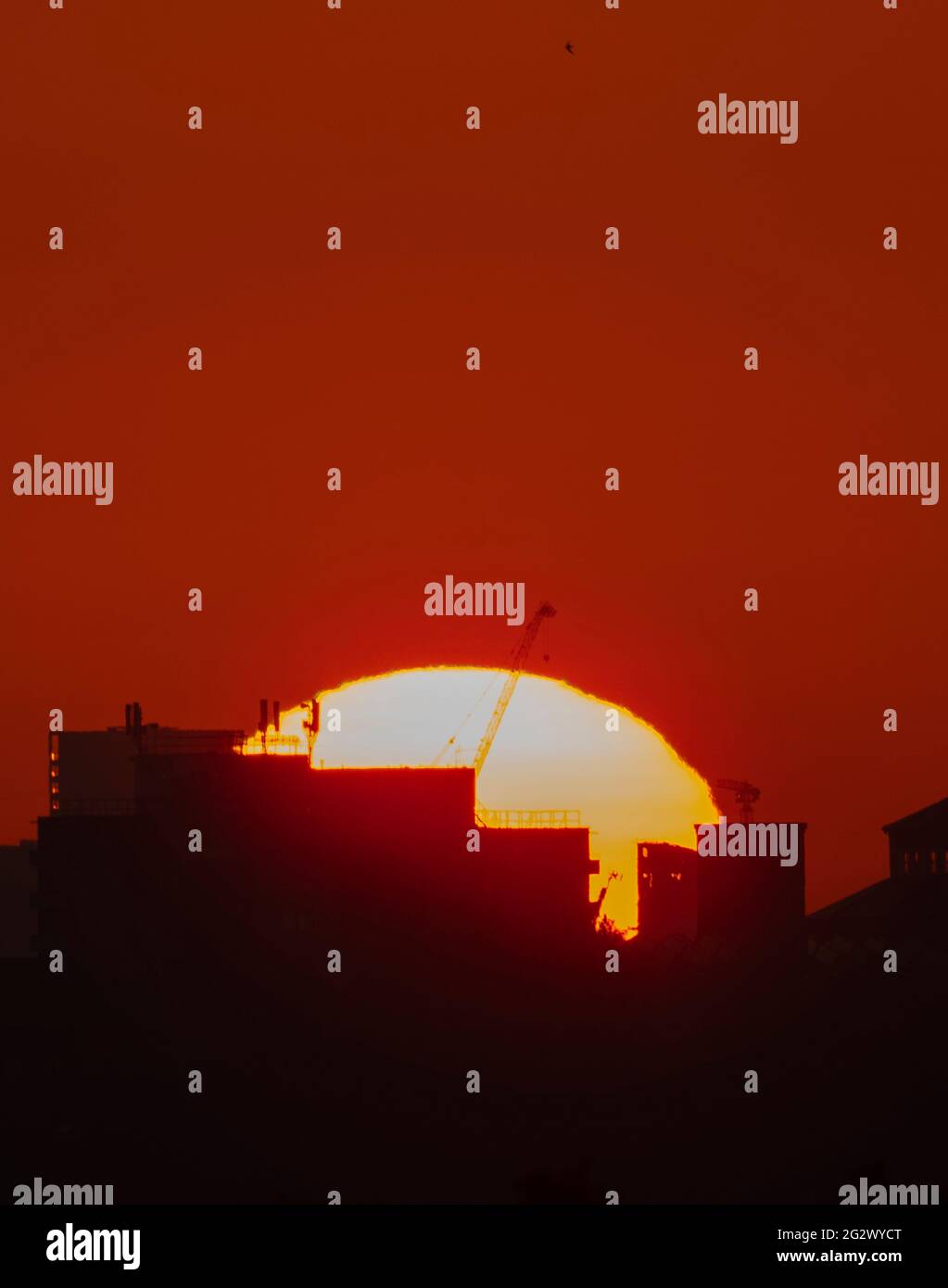 Wimbledon, London, UK. 13 June 2021. Orange and cloudless dawn sky