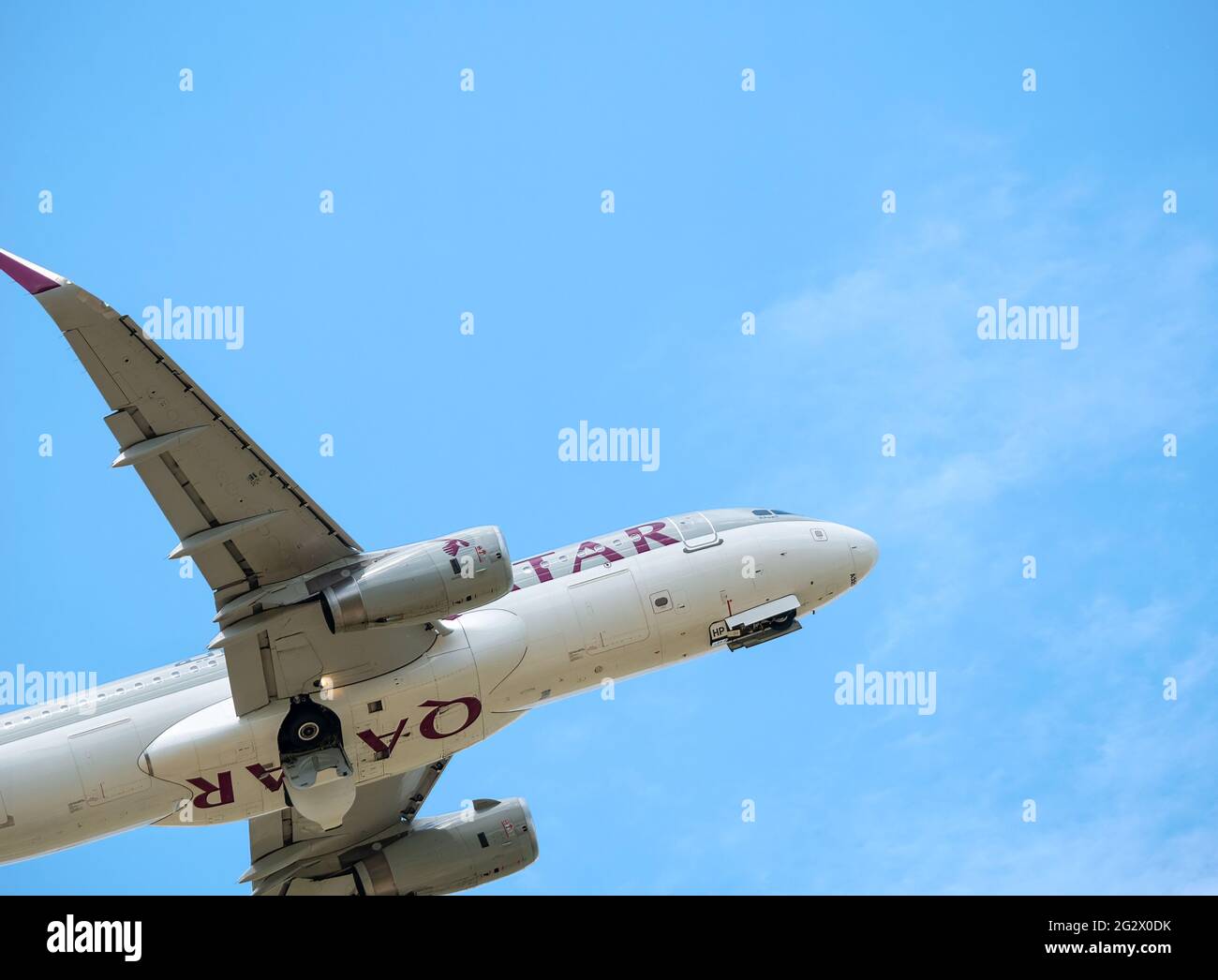 Otopeni, Romania - 05.14.2021: Qatar Airways Airbus A320-232 (A7-AHP) flying against blue sky. Airplane takes off from Henry Coanda International Airp Stock Photo