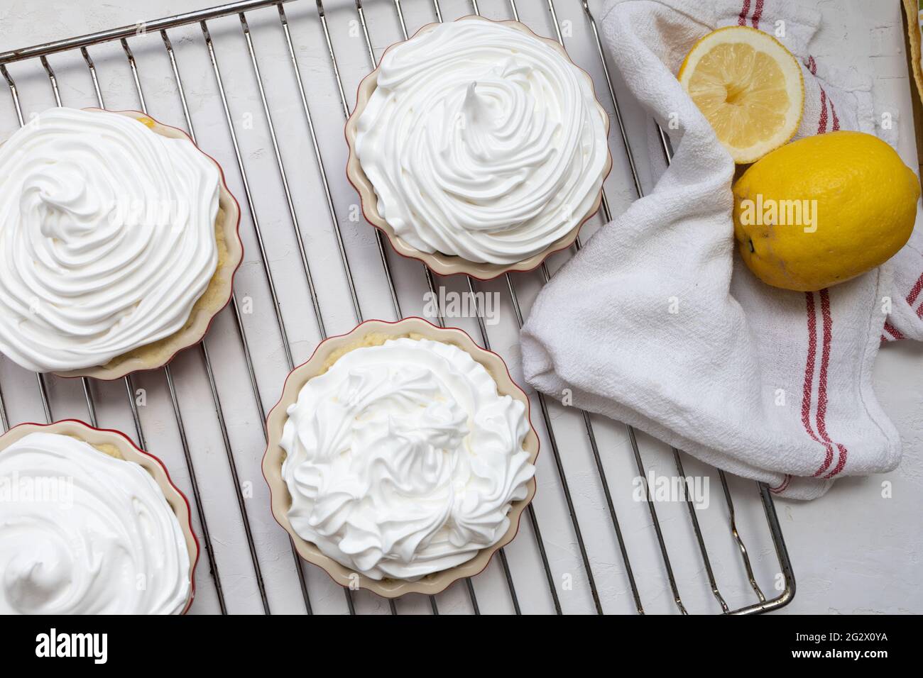 Lemon Meringue Tartlets before baking on a grid backing tray Stock Photo