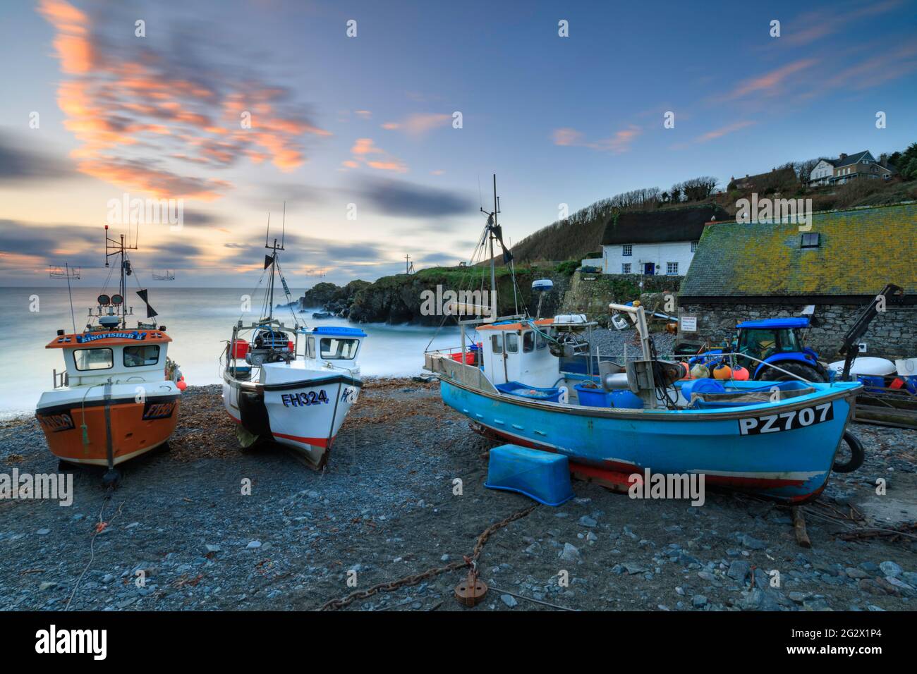 Cadgwith Cove in Cornwall captured from the beach at sunrise. Stock Photo