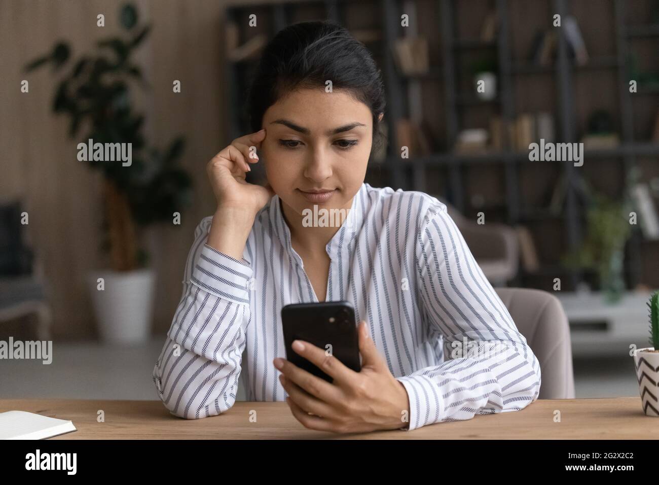 Side View Pleasant Millennial Mixed Race Woman Holding Smartphone