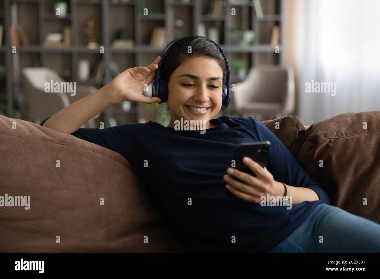 Satisfied young indian woman client enjoy easy learning foreign language Stock Photo