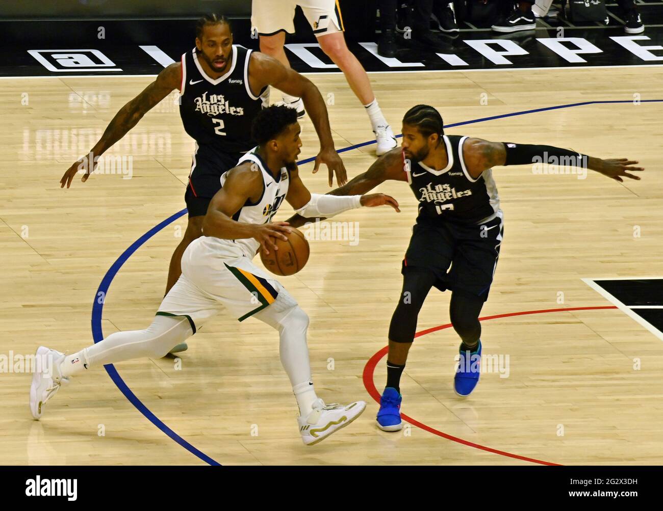 Los Angeles, Ca. 13th June, 2021. Utah Jazz guard Donovan Mitchell (45) drives against Los Angeles Clippers forward Kawhi Leonard (2) and guard Paul George (13) during the second half of Game 3 of the Western Conference second-round playoffs at Staples Center in Los Angeles on Saturday, June 12, 2021. The Clippers rallied to win another game 3, a 132-106 win over the Utah Jazz that cuts their deficit in this second-round series to 2-1 entering Monday's fourth game. Photo by Jim Ruymen/UPI Credit: UPI/Alamy Live News Stock Photo