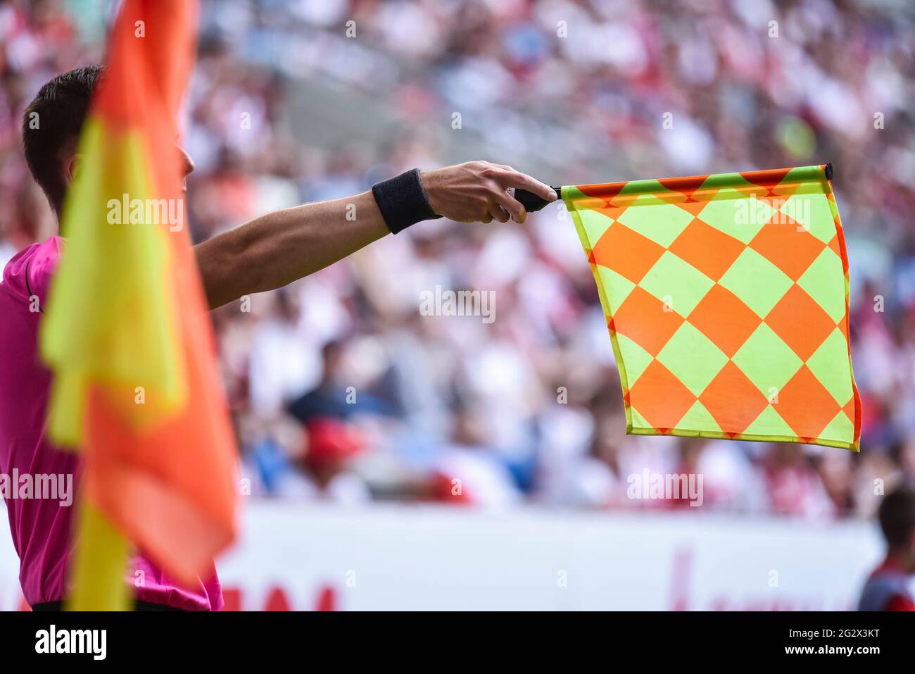 Hand of assistant of football referee with raised flag Stock Photo Alamy