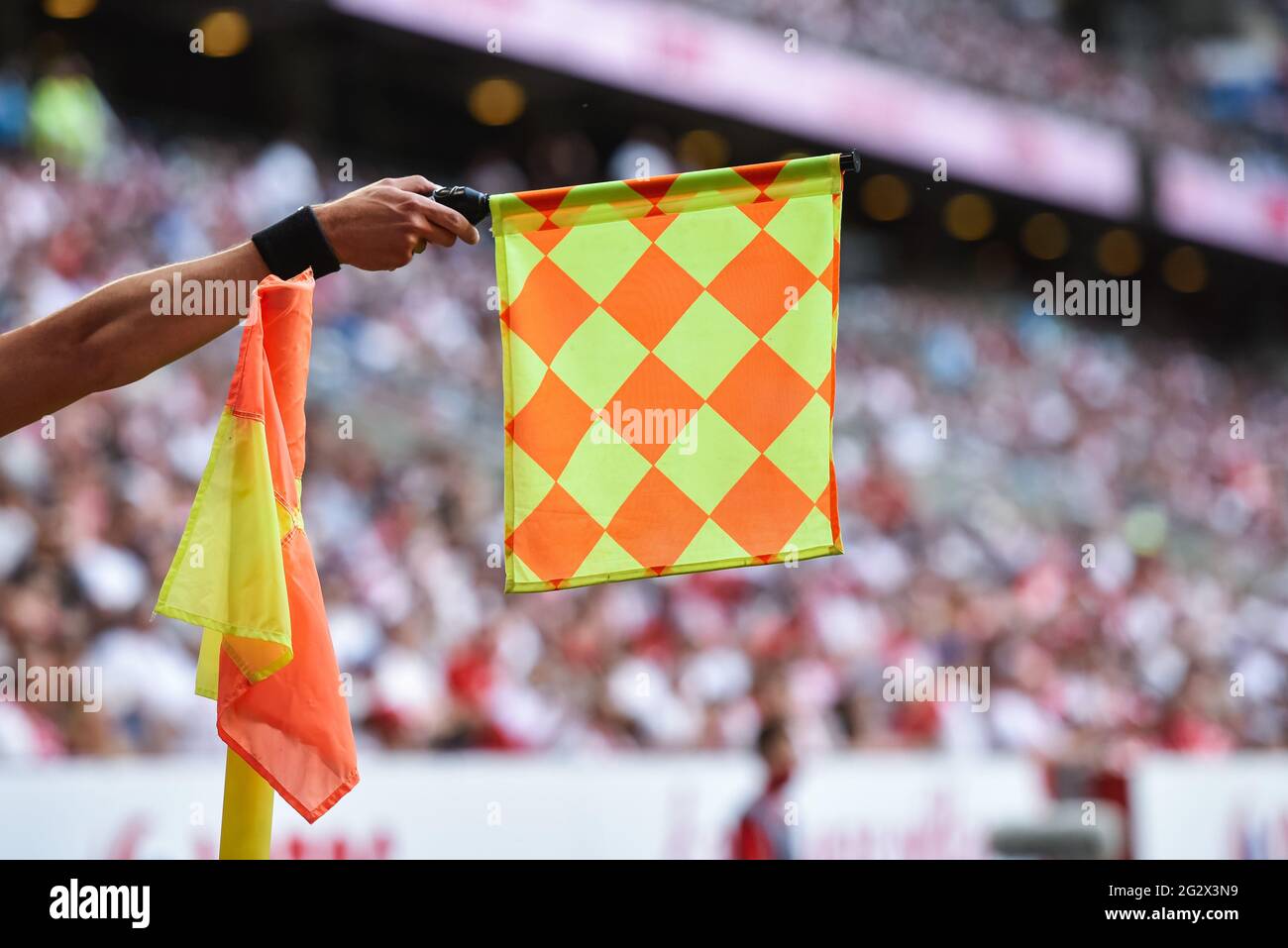 Hand of assistant of football referee with raised flag Stock Photo Alamy