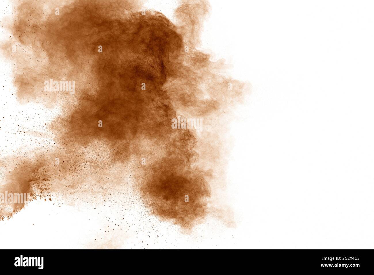 Brown dust explosion cloud.Brown particles splatter on white background. Stock Photo