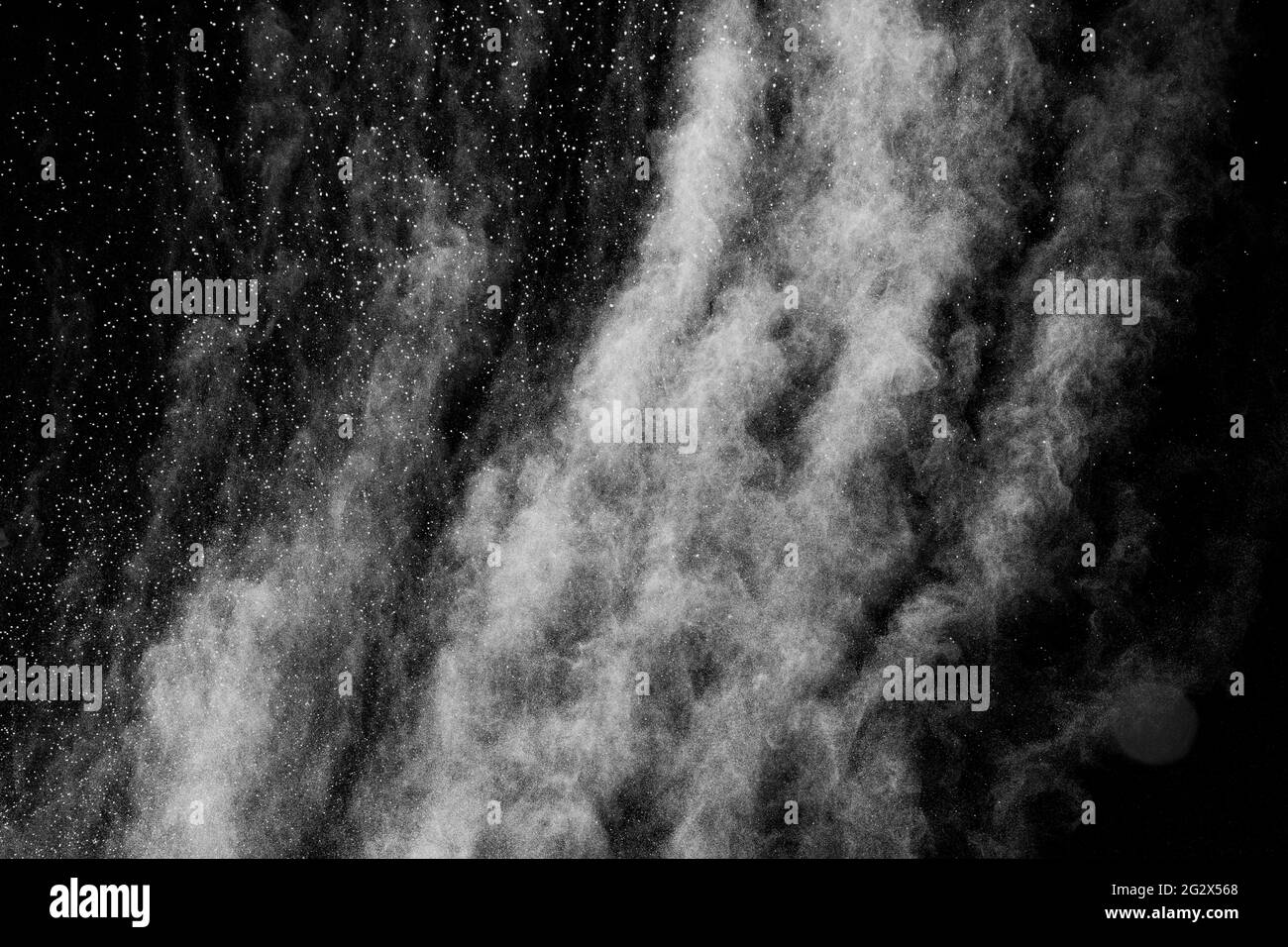 White powder explosion isolated on black background.White dust particles splash. Stock Photo