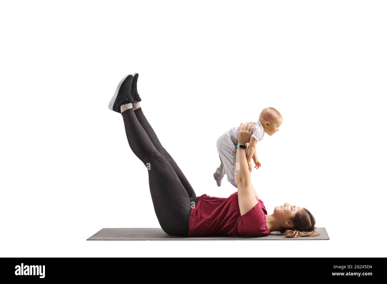 Mother exercising with her baby isolated on white background Stock Photo