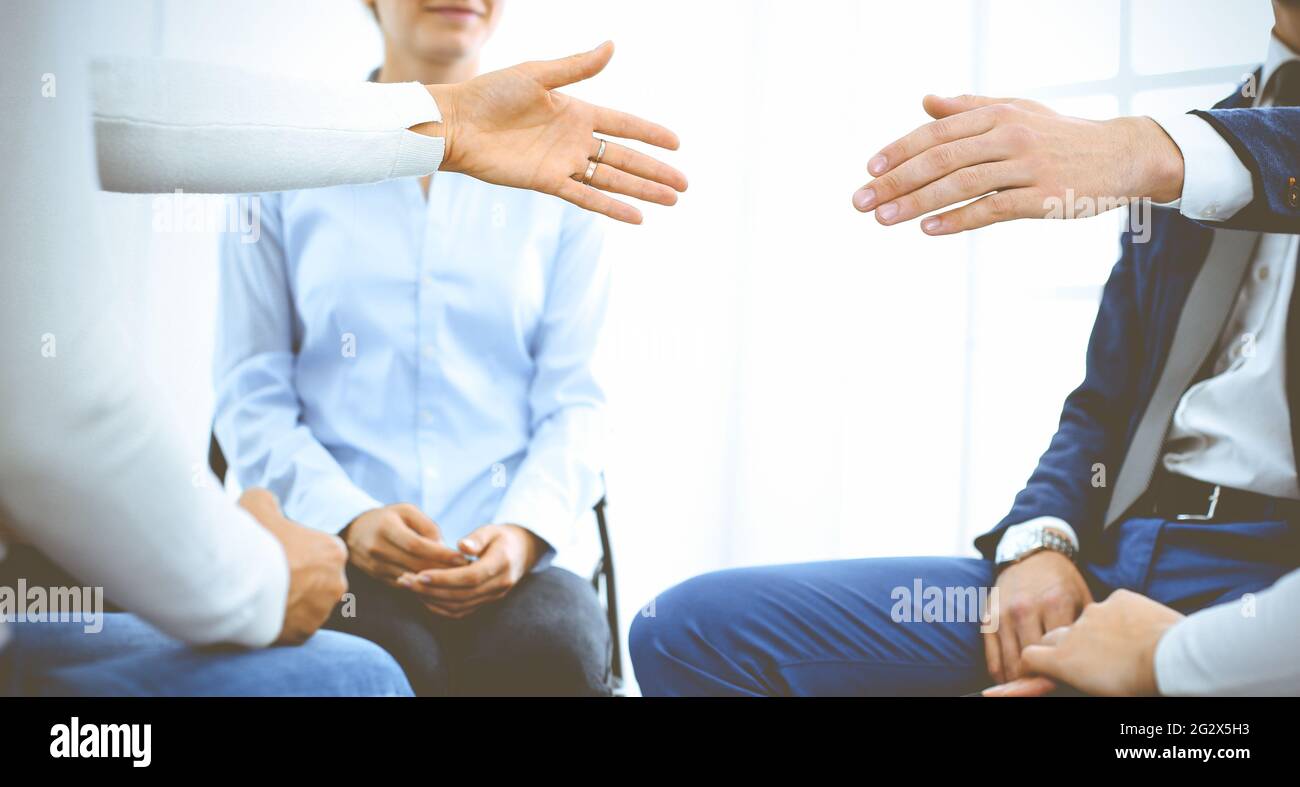 Group of people sitting in a circle during therapy. Meeting of business team participating in training Stock Photo