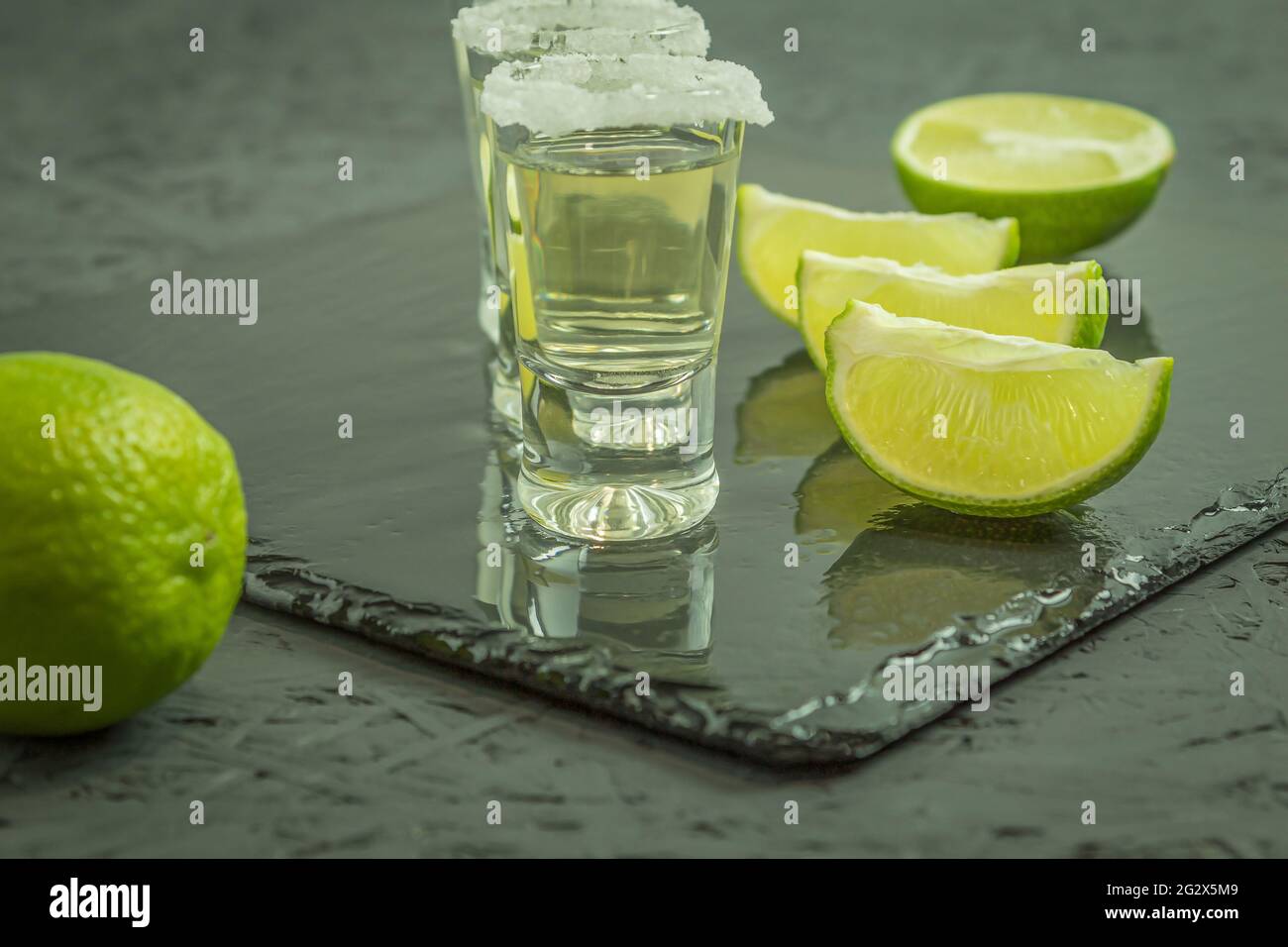 The glasses are filled with tequila and lime and salt. Aged tequila and