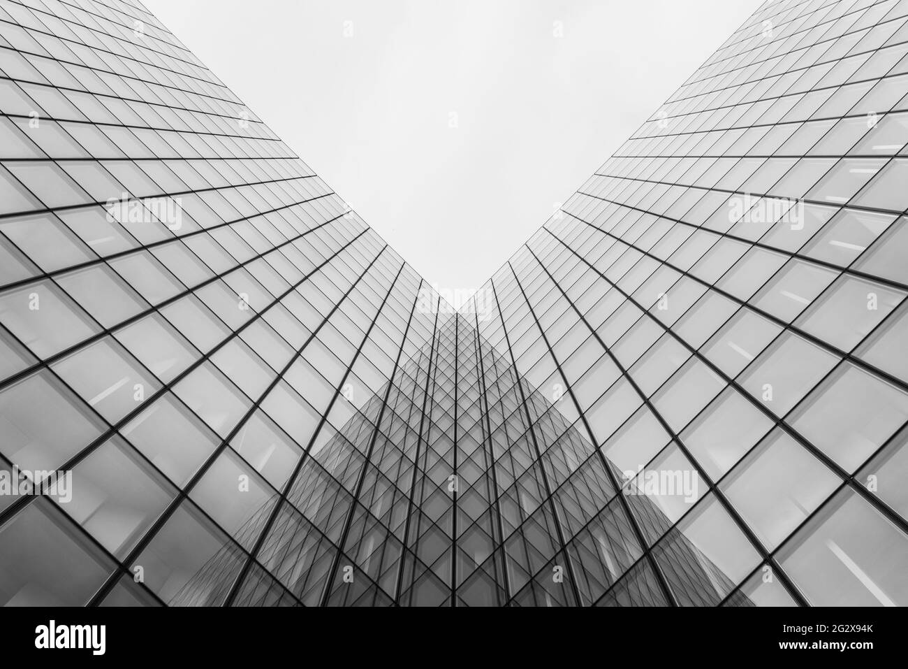 A grayscale shot of a modern building with glass walls Stock Photo - Alamy