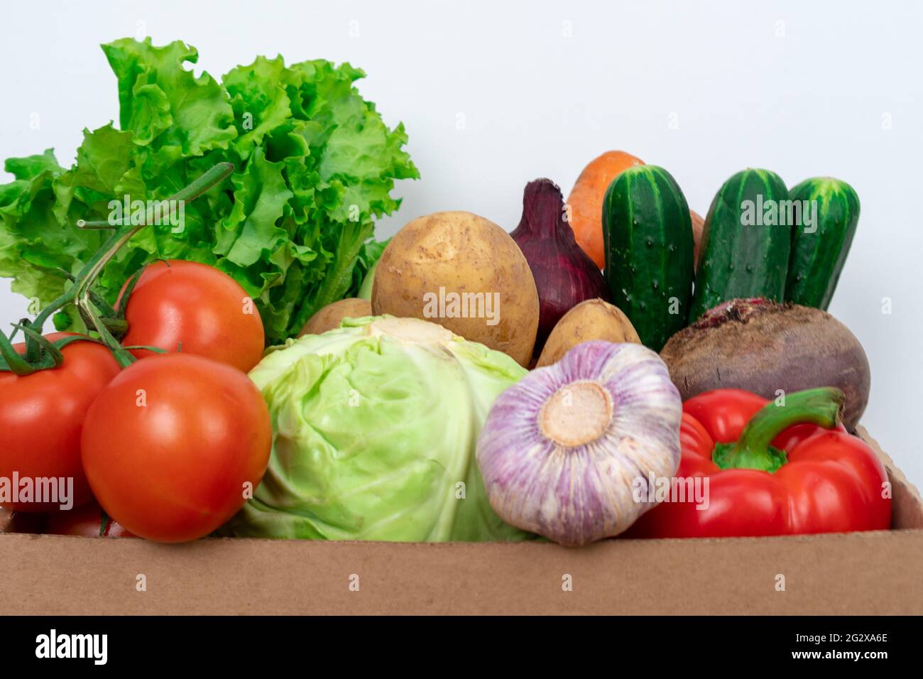 Closeup Fresh vegetables in a cardboard box on a white background. Fresh and healthy food