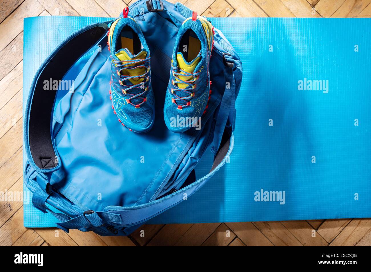 Sports bag and sneakers. Blue duffel bag and blue trainers. Sports composition. Top. Stock Photo