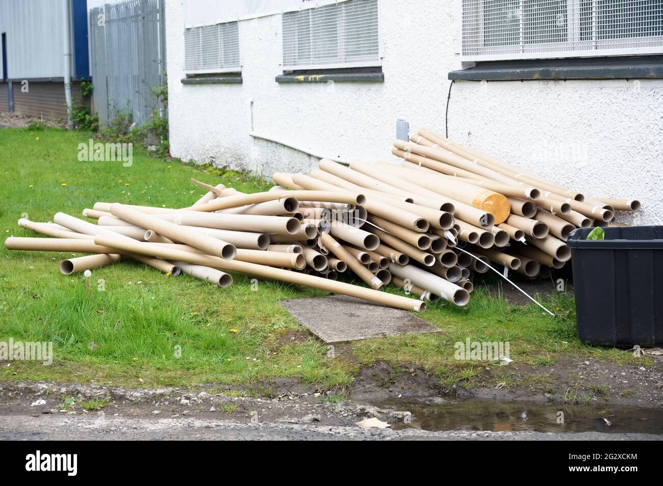 Cardboard tubes and rubbish dumped outside building Stock Photo Alamy