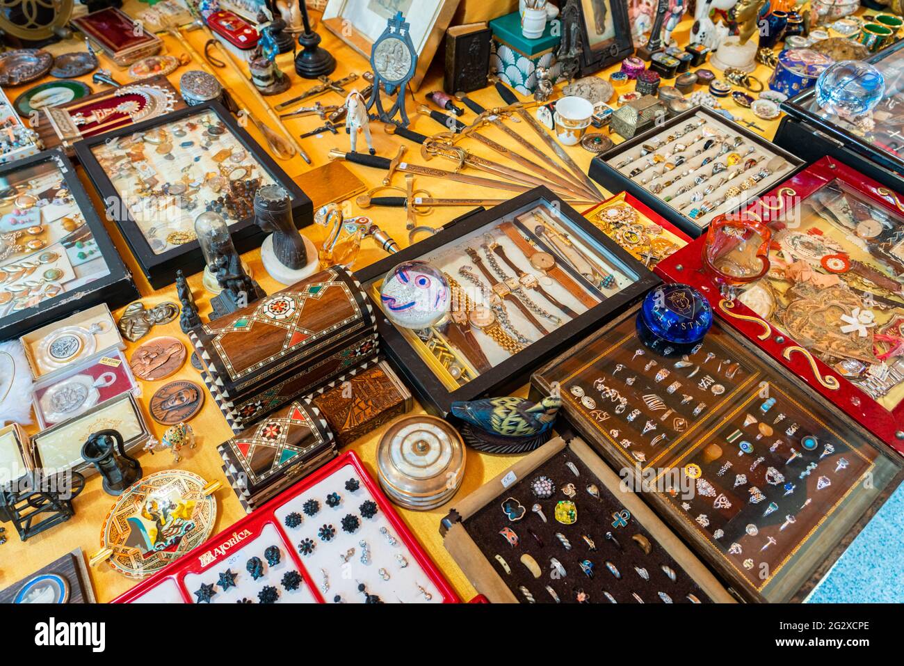 BARCELONA, SPAIN - JUNE 10, 2019: Antique objects, coins, jewels, tableware and other utensils at a flea market Stock Photo