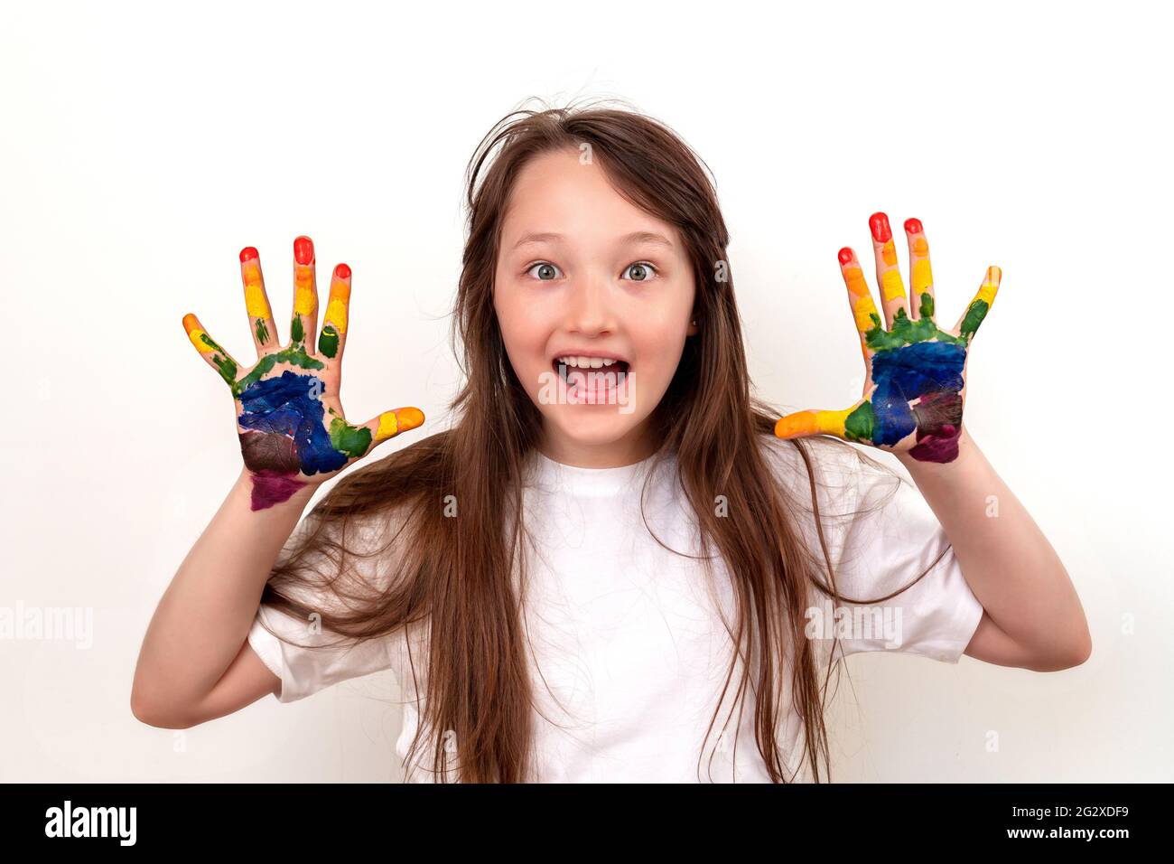 Portrait of a happy and smiling girl with multicolored palms. The girl