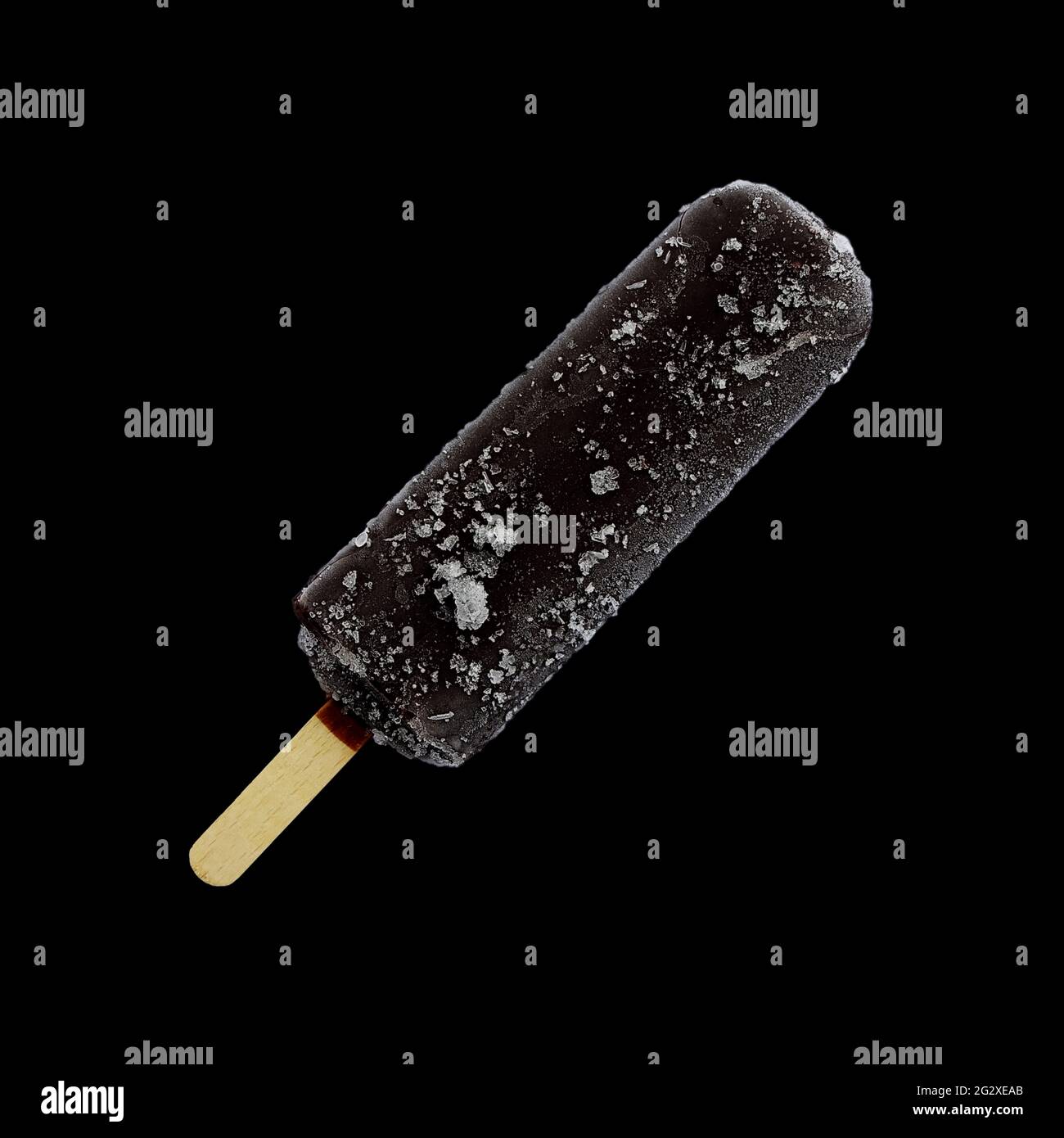 Chocolate ice cream lolly, chocolate glaze close-up with condensate and icing frost  isolated on black background. Ice cream bar,summer hot day. Stock Photo