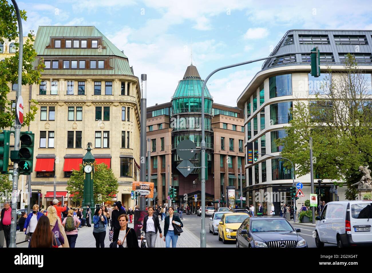 Shopping street in Düsseldorf city centre. The building with the green glass atrium is the shopping mall Schadow-Arkaden. Stock Photo