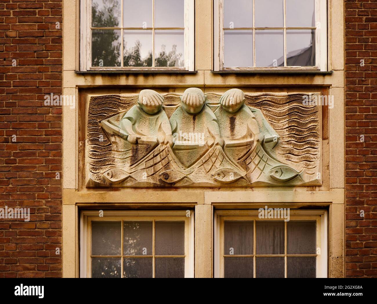 Decoration depicting fisherman on an old building in the historic old town in Düsseldorf, Germany. Stock Photo