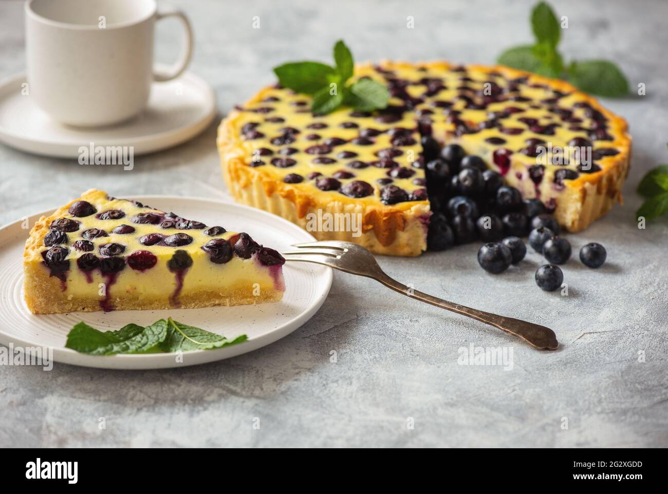 Homemade blueberry custard tart on light background. Stock Photo