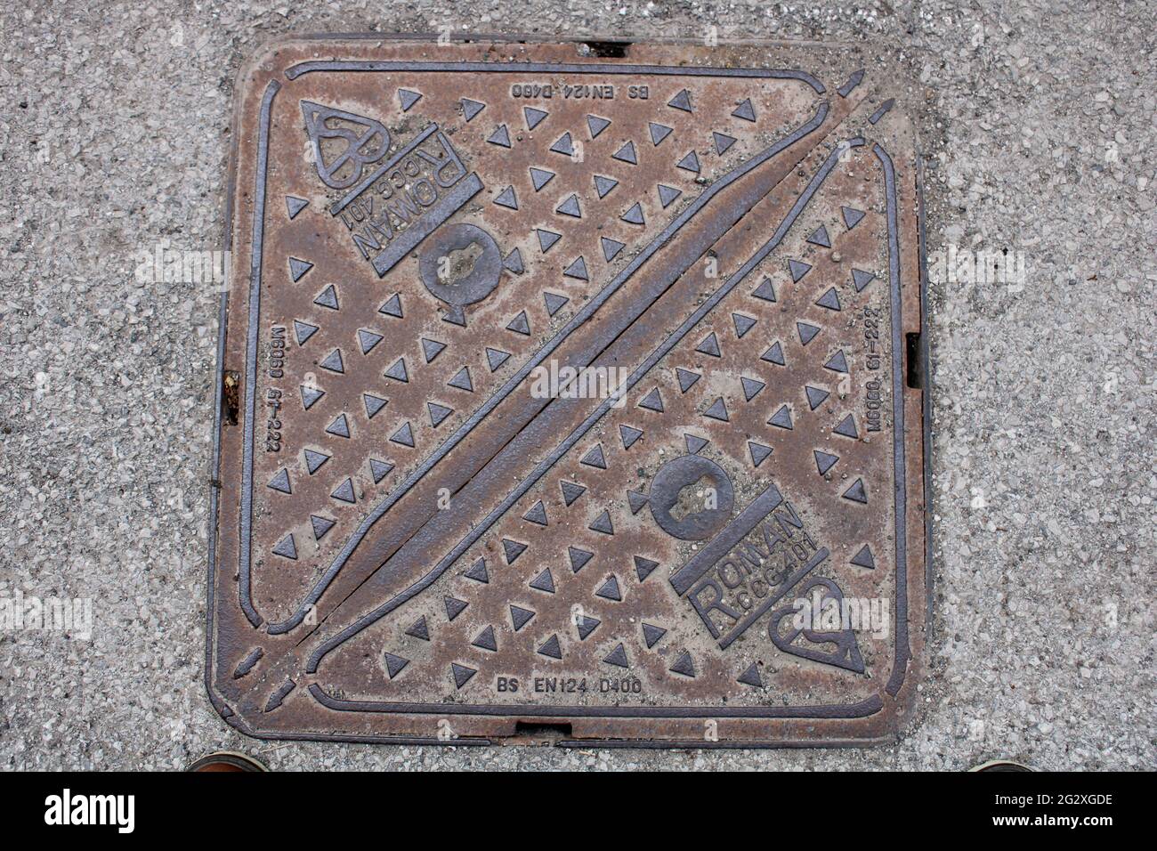 Textured manhole cover, Roman CCG 401 manhole cover Stock Photo