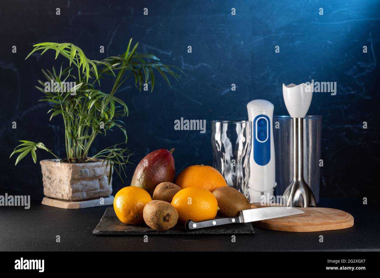 Fruit and blender. Making fruit smoothies. Knife and blender. Front