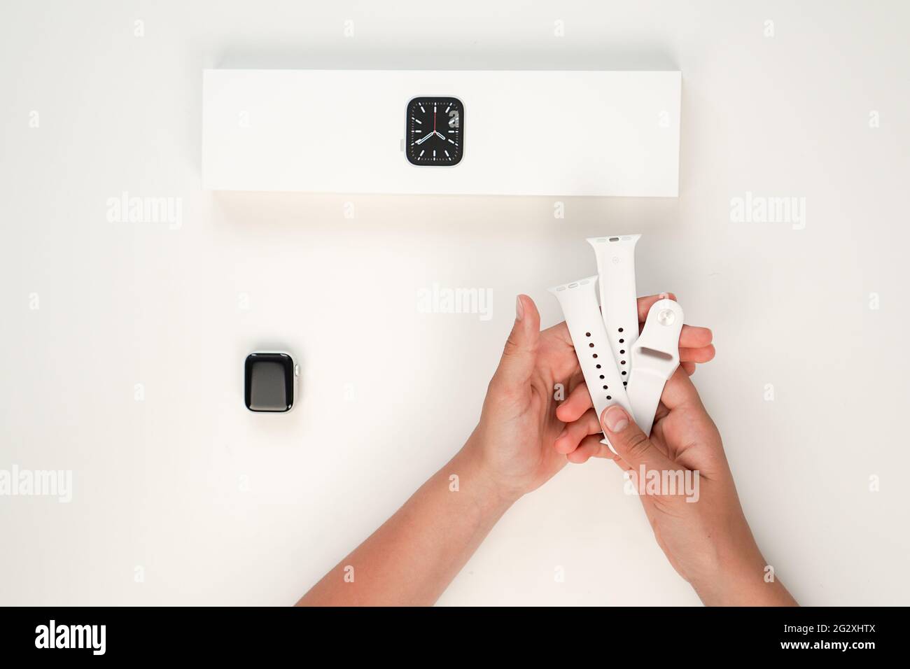 Unpacking of a new Apple Watch Series 6 40mm Silver Aluminum Case White Sport Band on White Background. Step six. Russia, Tatarstan, June 10, 2021. Stock Photo