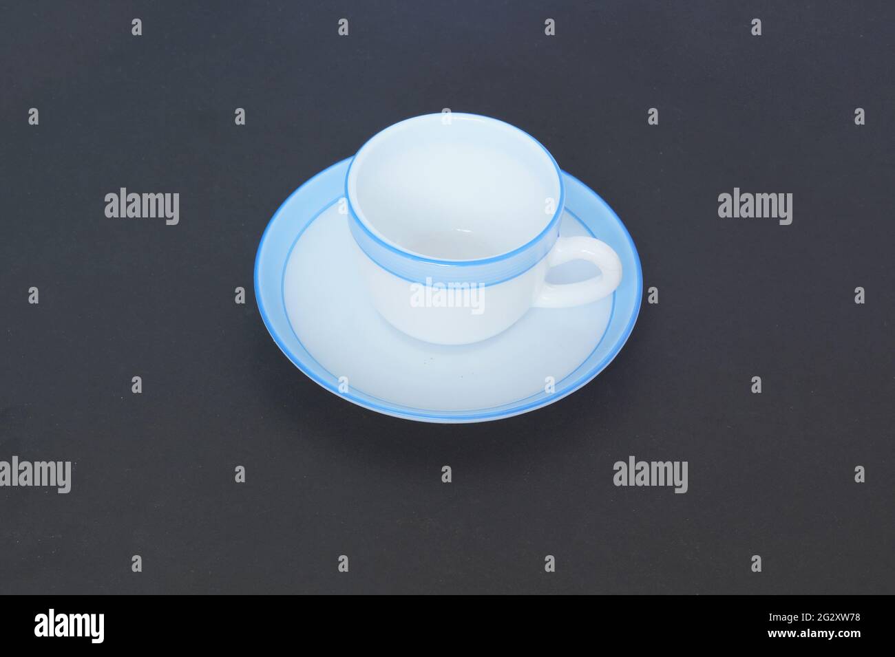 Cup and saucer in a dark background Stock Photo