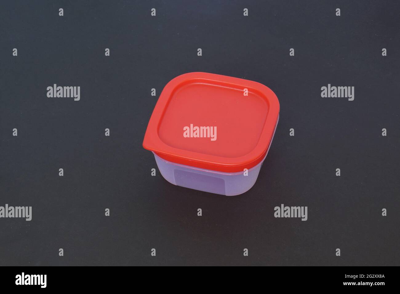 Square Plastic container in a dark background Stock Photo