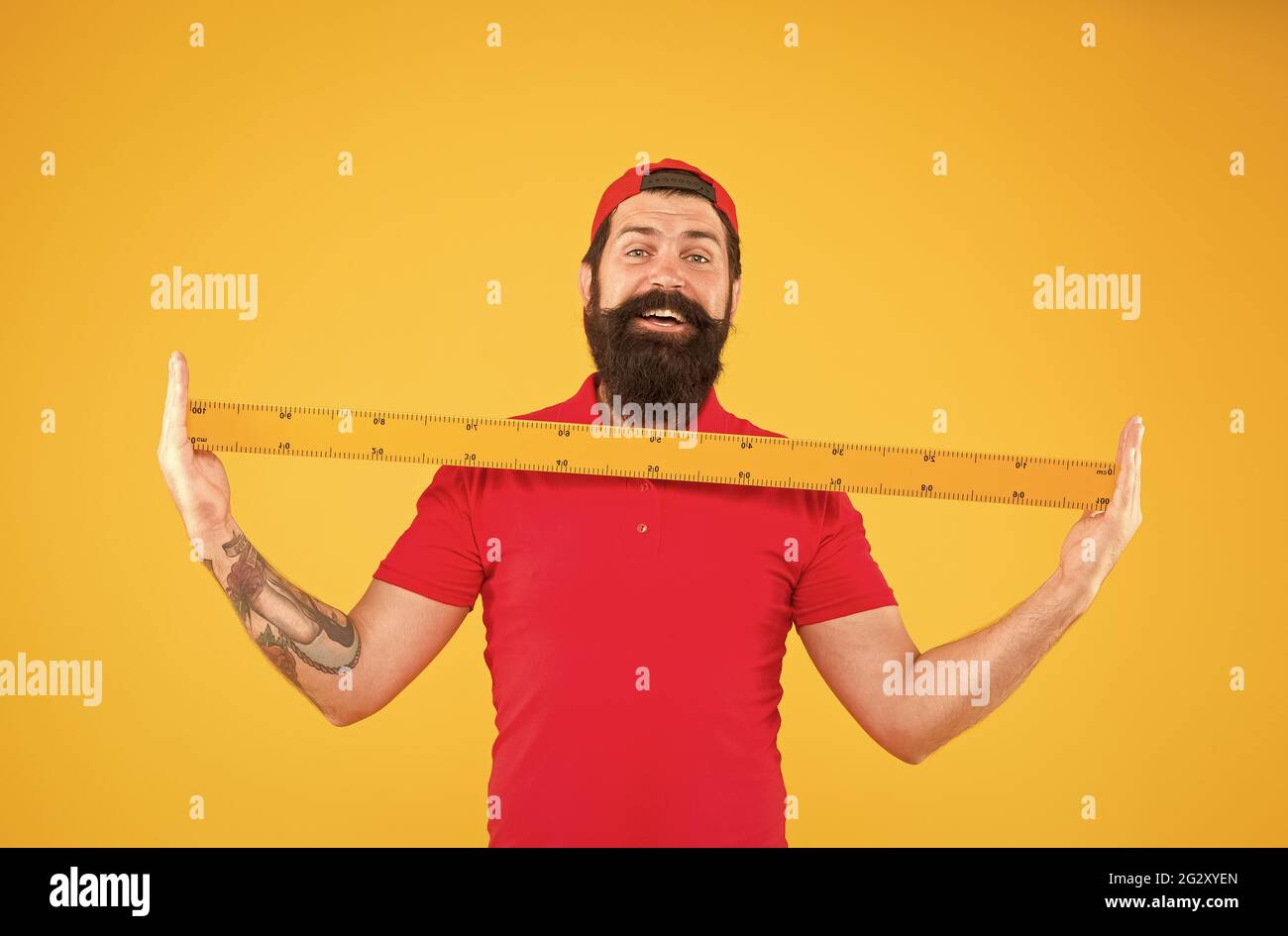 Hipster man in cap with big measuring instrument. Size of parcel. Post ...