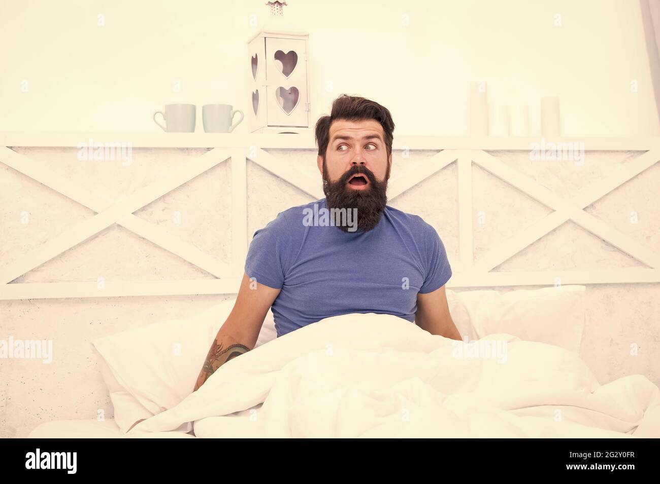 amazed bearded man hipster surprised about morning erection, mens health concept Stock Photo