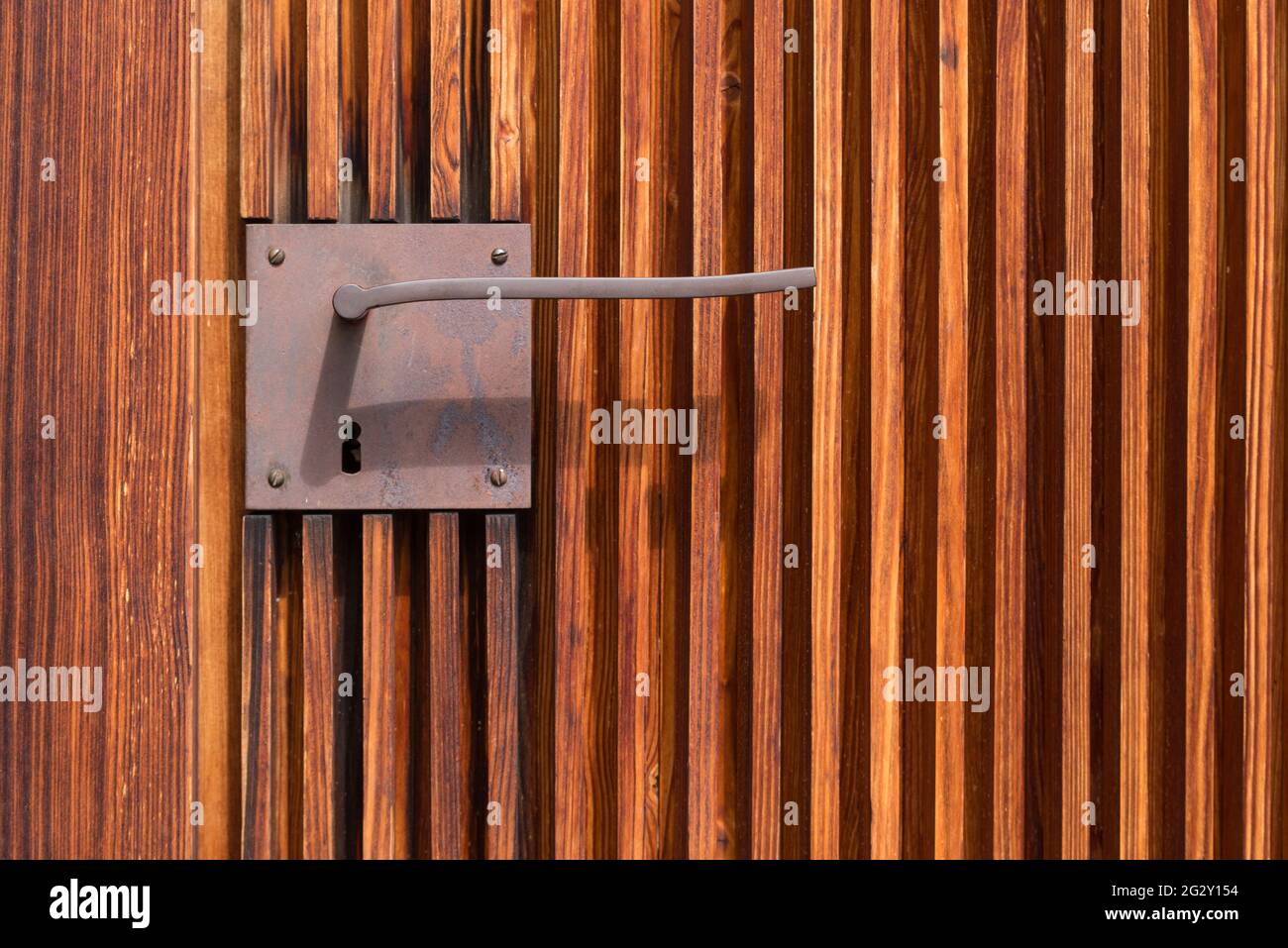 A wooden door with an old metal lock Stock Photo - Alamy