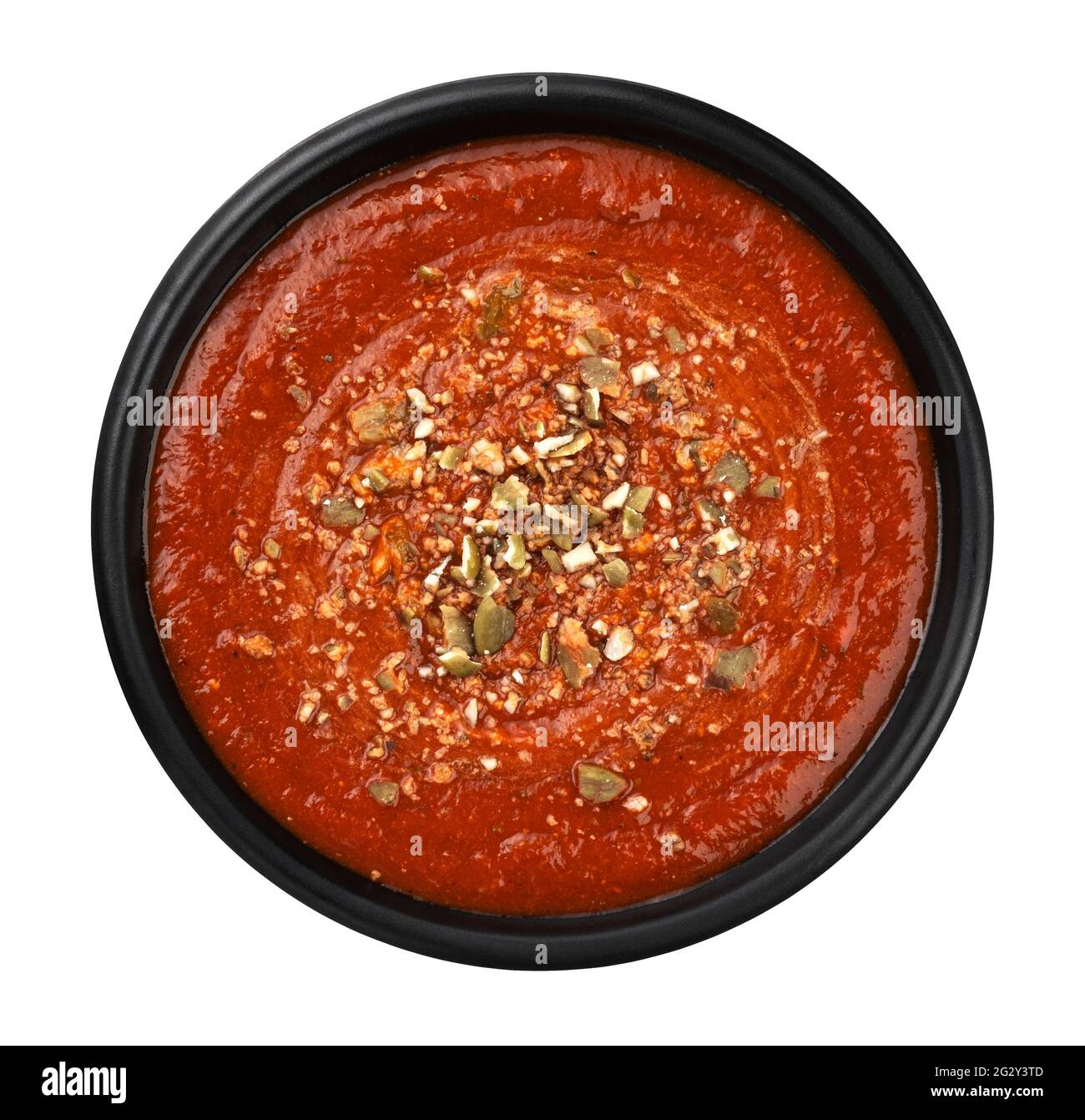 Bowl of tomato soup in black plate isolated on white background, top view Stock Photo