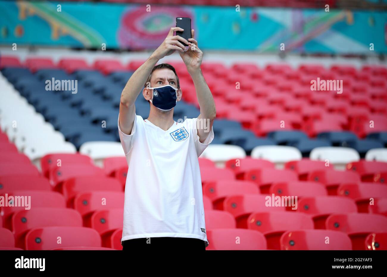 An England fan takes a photograph from the stands before the UEFA Euro ...