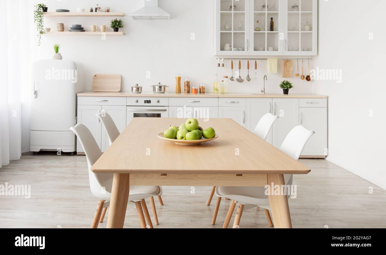 Modern scandinavian kitchen interior with various accessories. White kitchen furniture with household items on shelves Stock Photo