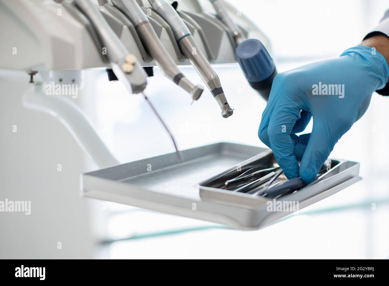 Closeup Shot Of Dentists Hand In Blue Glove Taking Sterile Stomatological Tools Stock Photo