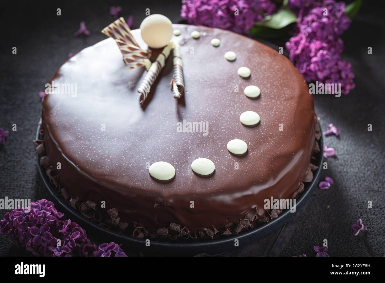 Dark chocolate cake with summer flowers. Sweet chocolate dessert. Vegan ...