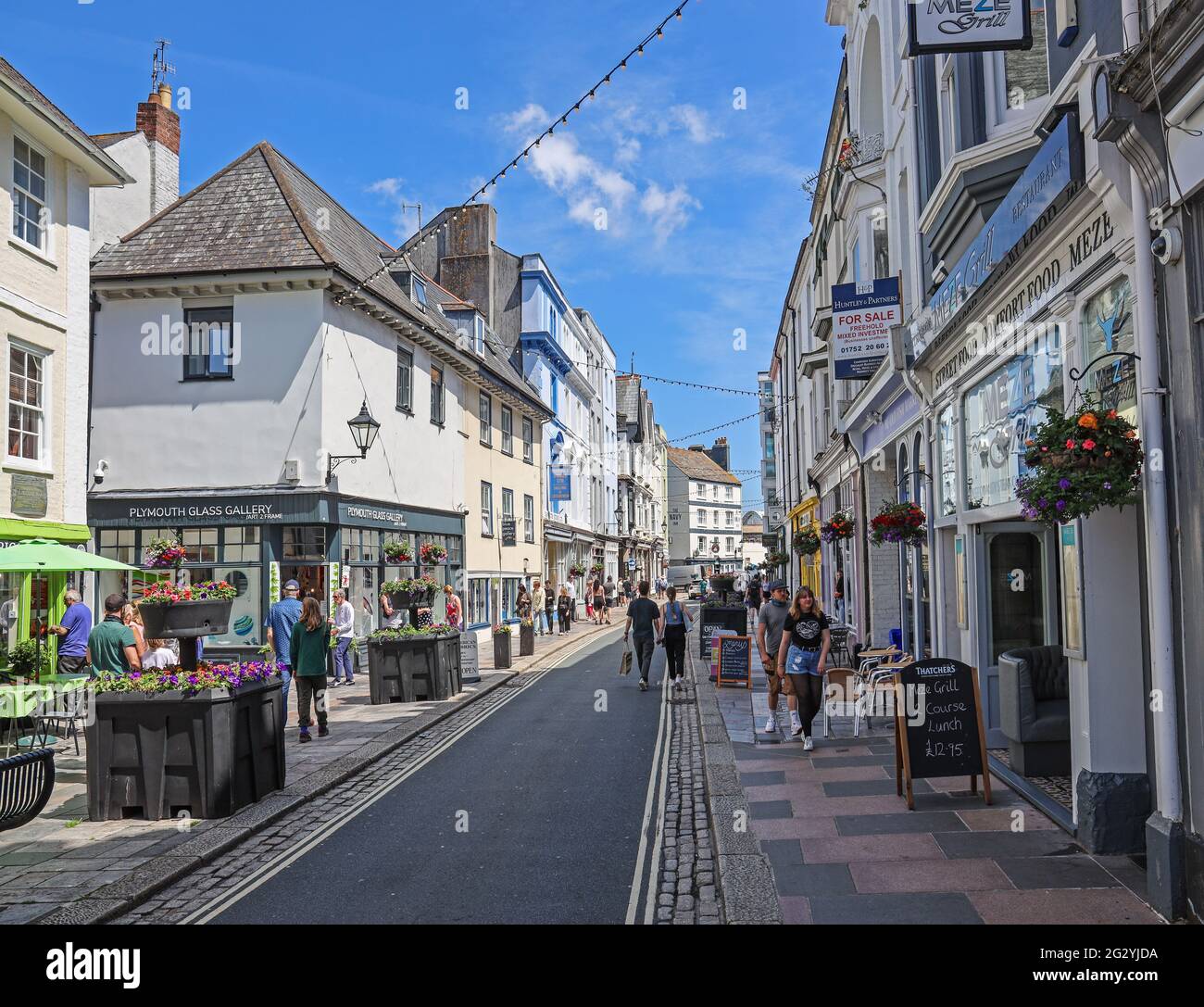 Lined with restaurants and arty shops, Plymouth’s historic Southside Street is happy to welcome back shoppers as lockdown eases in early June 2021 Stock Photo