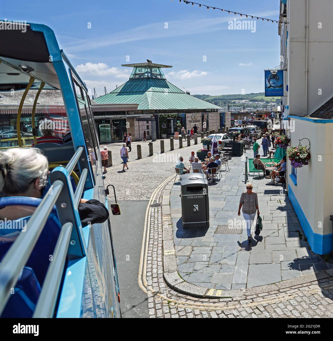 A journey through Southside Street Plymouth on the Ocean City Sights open topped bus. Below groups catch up at the Dolphin pub as lockdown eases whils Stock Photo