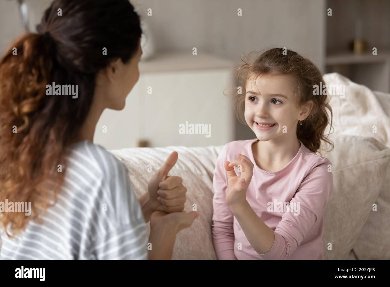 Little ethnic girl child talk using sign language Stock Photo