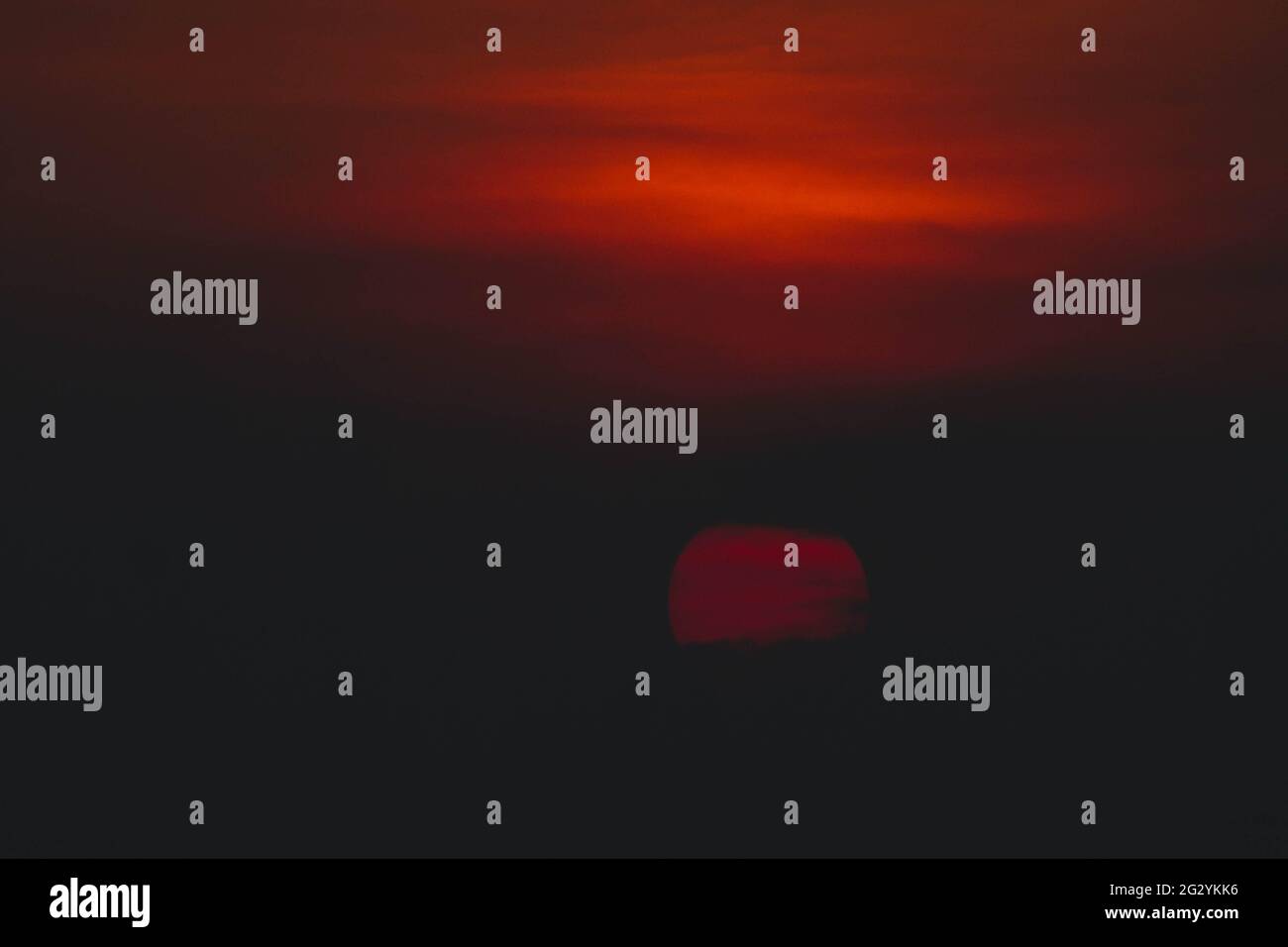 Beautiful sunset. Dramatic Fiery Sun Surrounded by Clouds During Sunset ...