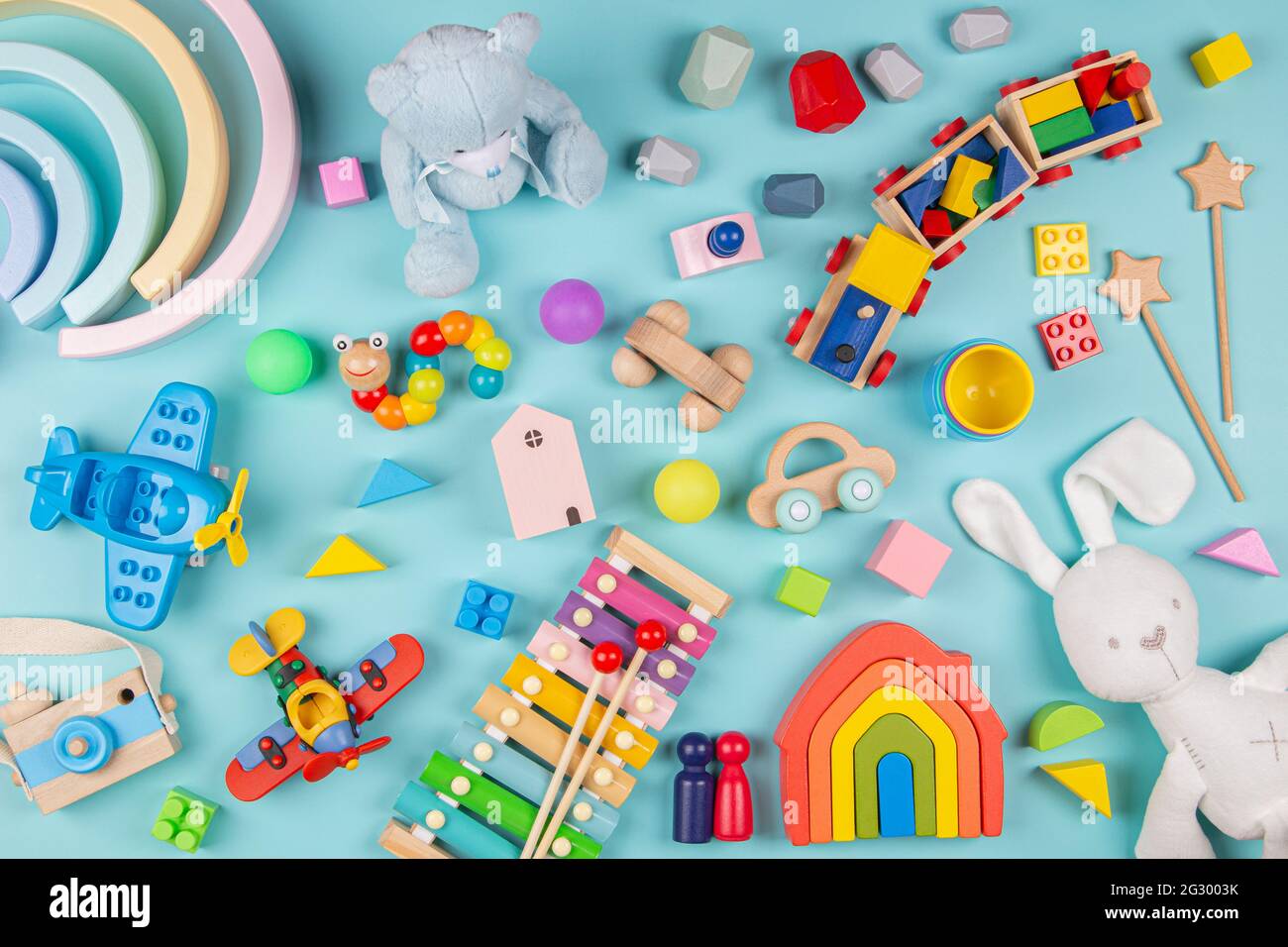 Baby kids toys pattern. Set of colorful educational wooden and fluffy toys on blue background. Top view, flat lay Stock Photo