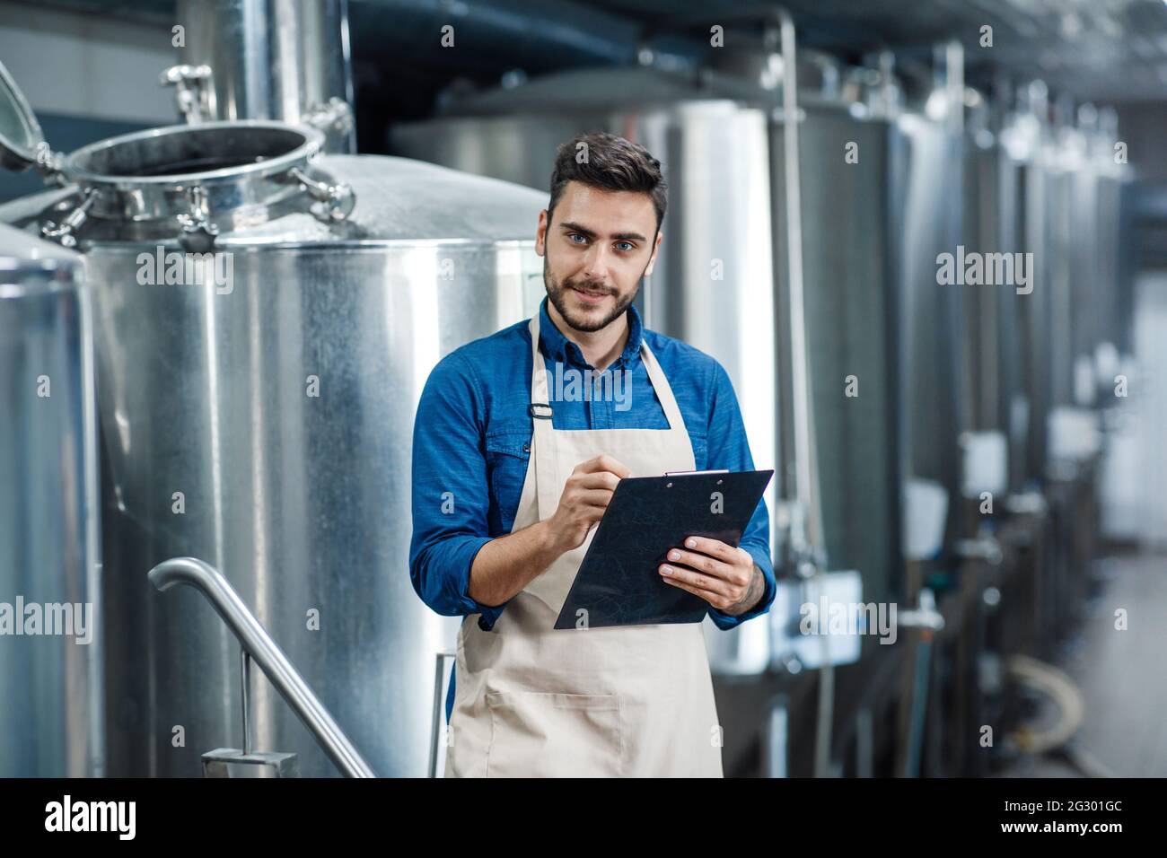 Beer production process, brewing at brewery. Plant management to make craft alcohol Stock Photo
