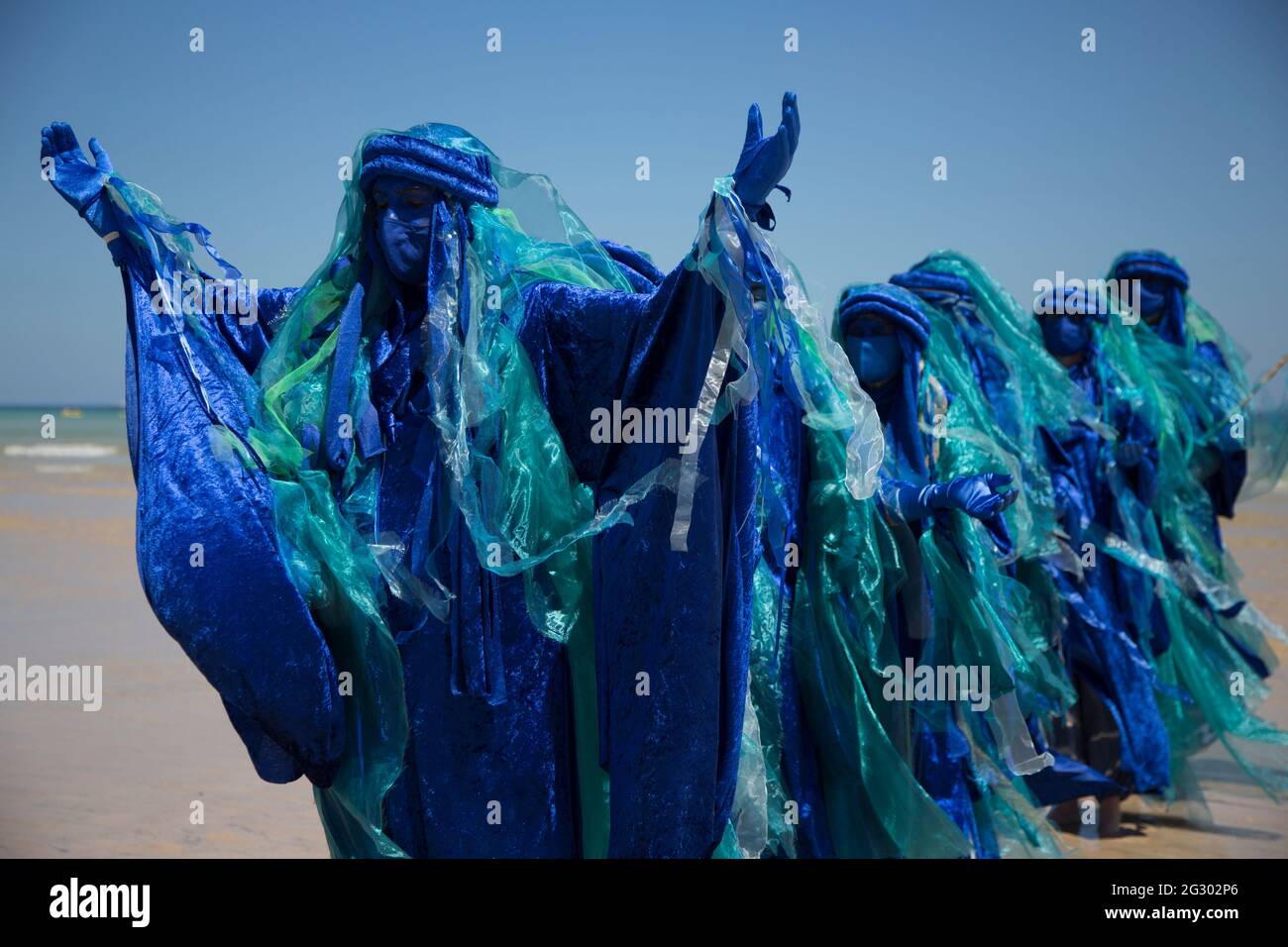 St Ives, UK. 13th June 2021. Extinction Rebellion's blue-robed Ocean Rebels protest on the beach in St Ives on the final day of the G7 Summit in Cornwall when climate change dominated the agenda. Credit: Sarah Peters/Alamy Live News Stock Photo