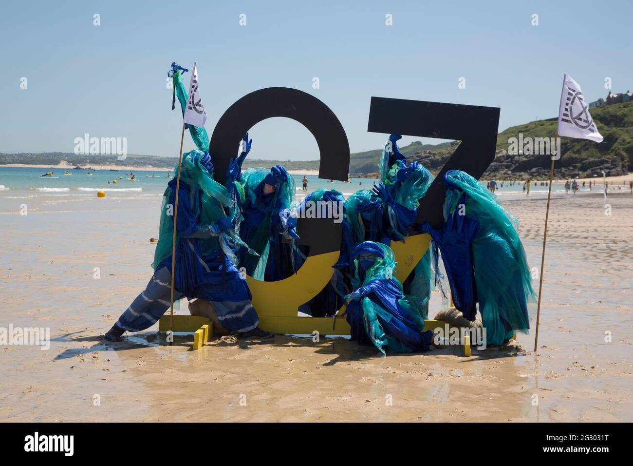 St Ives, UK. 13th June 2021. Extinction Rebellion's blue-robed Ocean Rebels protest on the beach in St Ives, Cornwall on the final day of the G7 Summit when climate change dominated the agenda. Credit: Sarah Peters/Alamy Live News Stock Photo