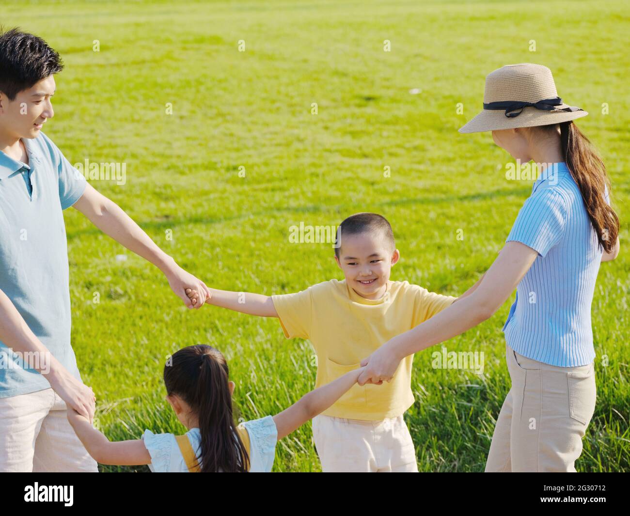 Happy family of four playing in the park high quality photo Stock Photo ...