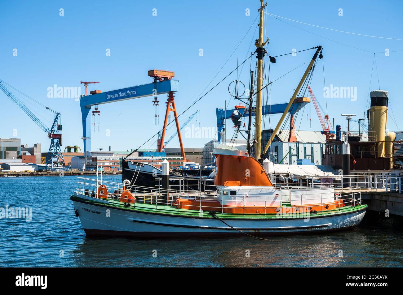 Kiel, Alte traditionelle Schiffe im Museumshafen sind zur Besichtigung frei gegeben, im Hintergrund die Werftanlagen im Stadtteil Gaarden auf dem Ostu Stock Photo