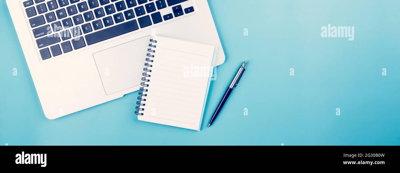 Flat lay of Laptop computer and plant and pen on desk in office, workplace and notebook and potted tree and book, workspace and copy space, top view, Stock Photo